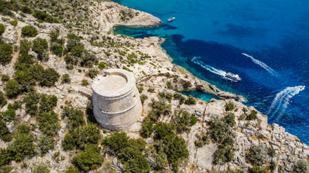 Aerial view of the Torre des Savinar, at the western tip of Ibiza island in the Balearic Islands, Spain - Medieval fortified tower overlooking the Mediterranean Seaの写真素材