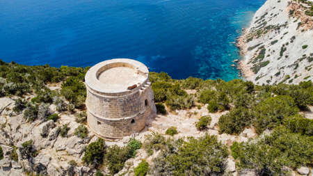 Aerial view of the Torre des Savinar, at the western tip of Ibiza island in the Balearic Islands, Spain - Medieval fortified tower overlooking the Mediterranean Seaの写真素材
