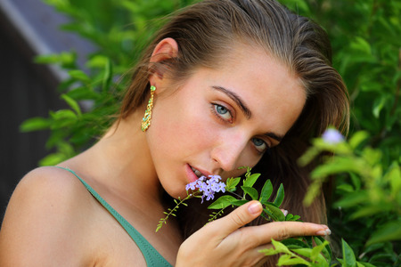 Sensual portrait of young beautiful girl with a flower の写真素材