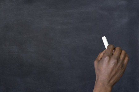 Man writing on a blackboardの写真素材