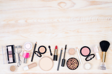 Makeup cosmetics on white, wooden background with copy space, top viewの写真素材