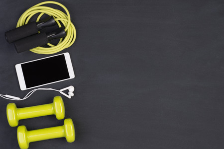 Fitness equipment on a blackboard with copy space
