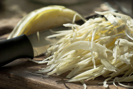 Cabbage sliced on chopping boardの写真素材