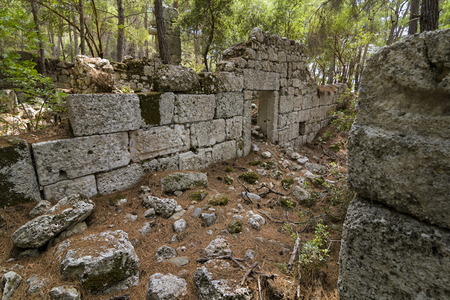 Stone ruins of houses and the street of the ancient city of Phaselis. Historical landmark Phaselis (Faselis) - the city of ancient Lycia, in the territory of modern Turkey, Antalya.の写真素材