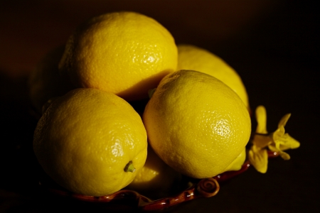 Lemons in a bowl on dark backgroundの写真素材