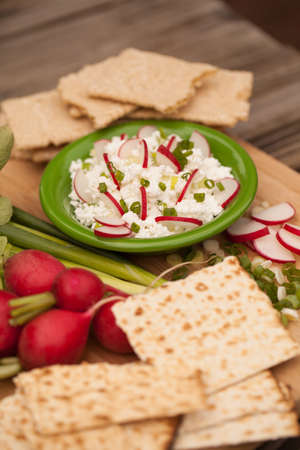 Cottage cheese with radish,chives and crackersの写真素材