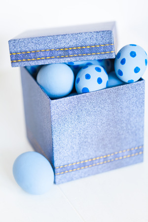 Easter eggs in a denim box.の写真素材