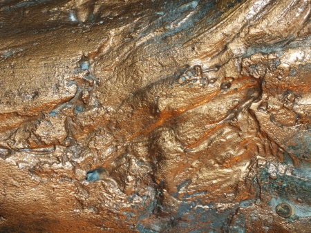 Uneven bronze surface with patina - to be used as backgroundの写真素材
