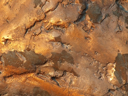 Uneven bronze surface with patina - to be used as backgroundの写真素材