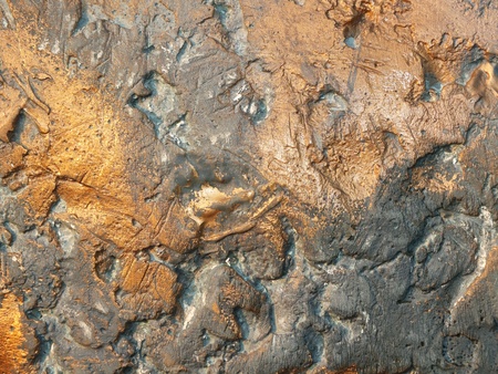 Uneven bronze surface with patina - to be used as backgroundの写真素材