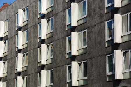 Facade of a modern apartment building with windows and blinds.の写真素材
