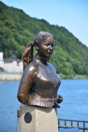 Statue of a girl on the embankment of the river Rhine in Germanyの写真素材