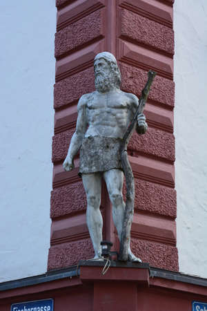 Sculpture of a man with a sword on the roof of the buildingの写真素材