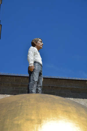 Statue of a man on the roof of a building in the city of Lvivの写真素材
