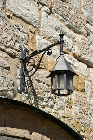 Old street lamp on a stone wall in the old town of Rovinj, Croatiaの写真素材