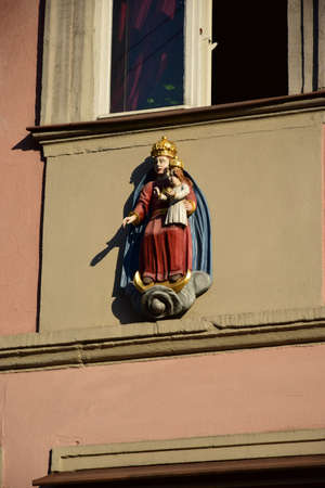 Statue of the Virgin Mary on the facade of a building in the old town of Riga, Latvia.の写真素材