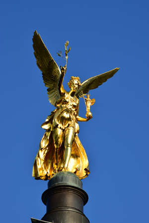 Golden angel statue on the top of a column in Berlin, Germanyの写真素材