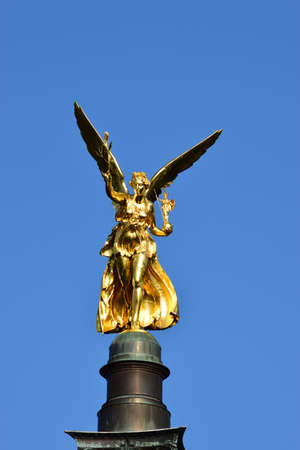 Golden winged angel on the top of the Charles Bridge in Pragueの写真素材