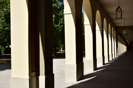 A vertical shot of a row of arches in a public parkの写真素材