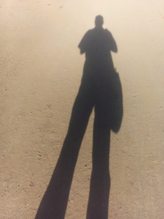 man shadow on road 