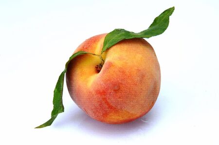 peach with leaf at white backgroundの写真素材