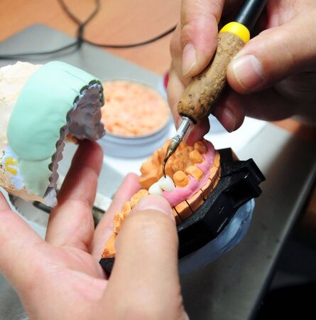 dentist technician hands at the work for tooth