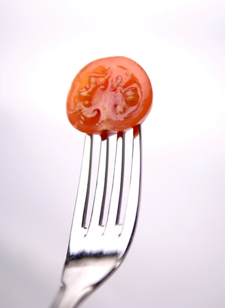 fresh red tomato serve with the fork の写真素材