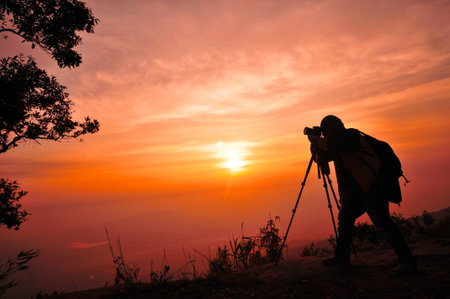 Sunrise silhouette of traveler man の写真素材