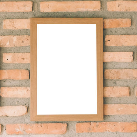 blank brown picture frame on brick wallの写真素材