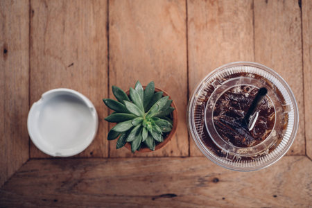 coffee shop background, plant coffee and ashtray on wood table in coffee shop.の写真素材