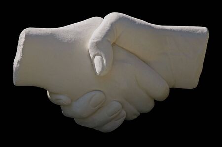 stone statue handshake on a black backgroundの写真素材