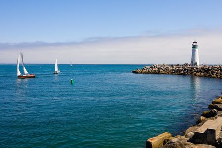 Lighthouse and sail boatsの写真素材