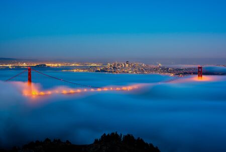 San Francisco and Golden Gate Bridge on a foggy nightの写真素材