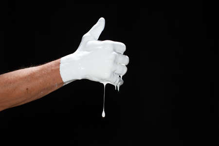 The hands of a man in white paint on a black backgroundの写真素材