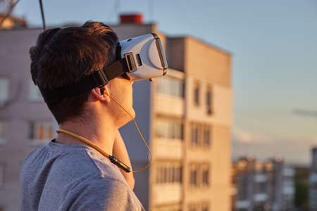 The guy in the virtual glasses. The boy looks into the virtual world. The guy admires the virtual...
