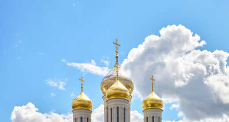 Golden domes of an Orthodox church against a blue sky.の写真素材
