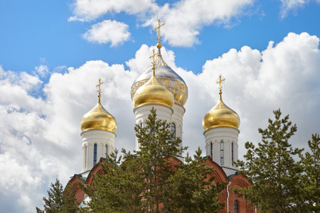 Golden domes of an Orthodox church against a blue sky.