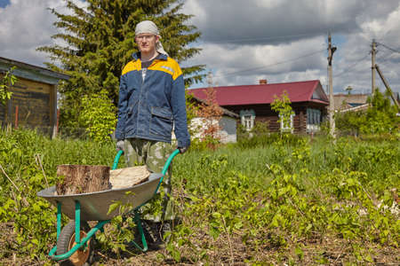 The guy works in the village against the blue sky