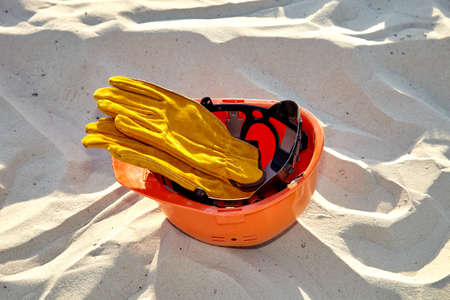 Construction helmet on the sand. Construction helmet on the construction site.