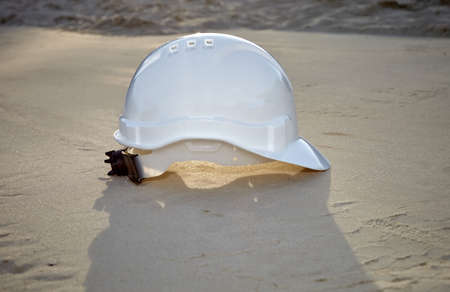 Construction helmet on the sand. Construction helmet on the construction site.の写真素材
