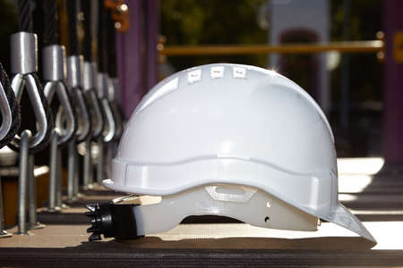 The construction helmet is white on the construction site.
