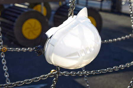 The construction helmet is white on the construction site.