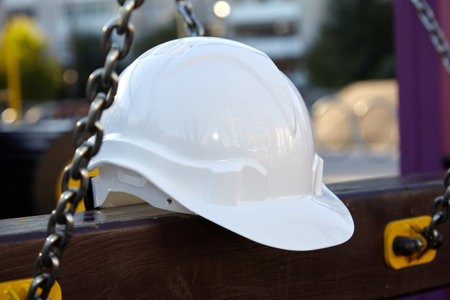 The construction helmet is white on the construction site.の写真素材