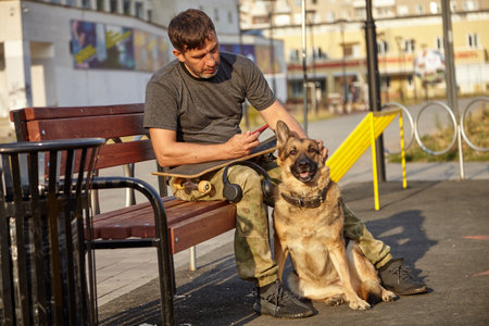 Skate and dog and man. Playing sports with a dog.の写真素材