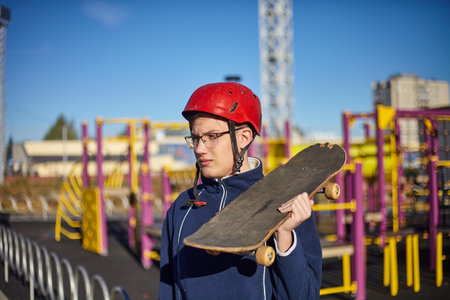 Skateboard and helmet. Fall protection red helmet.