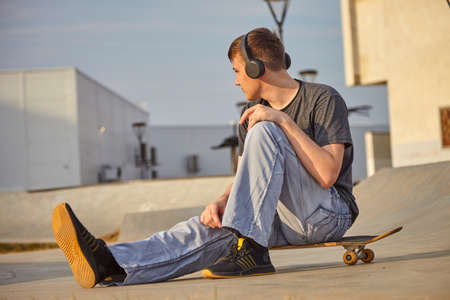 The guy is engaged on a skateboard. Skateboard in summer and student.の写真素材