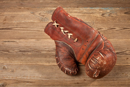 Boxing gloves. Old boxing gloves. Boxing gloves on a wooden table.の写真素材