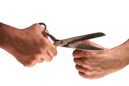 A man cuts his fingernails with a toolの写真素材