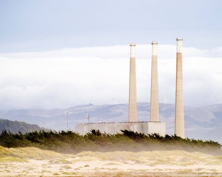 Three smoke stacks near beach.の写真素材