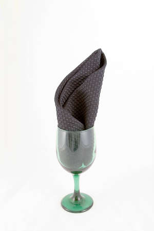 Green water goblet with black napkin inserted to give a holiday feeling.の写真素材